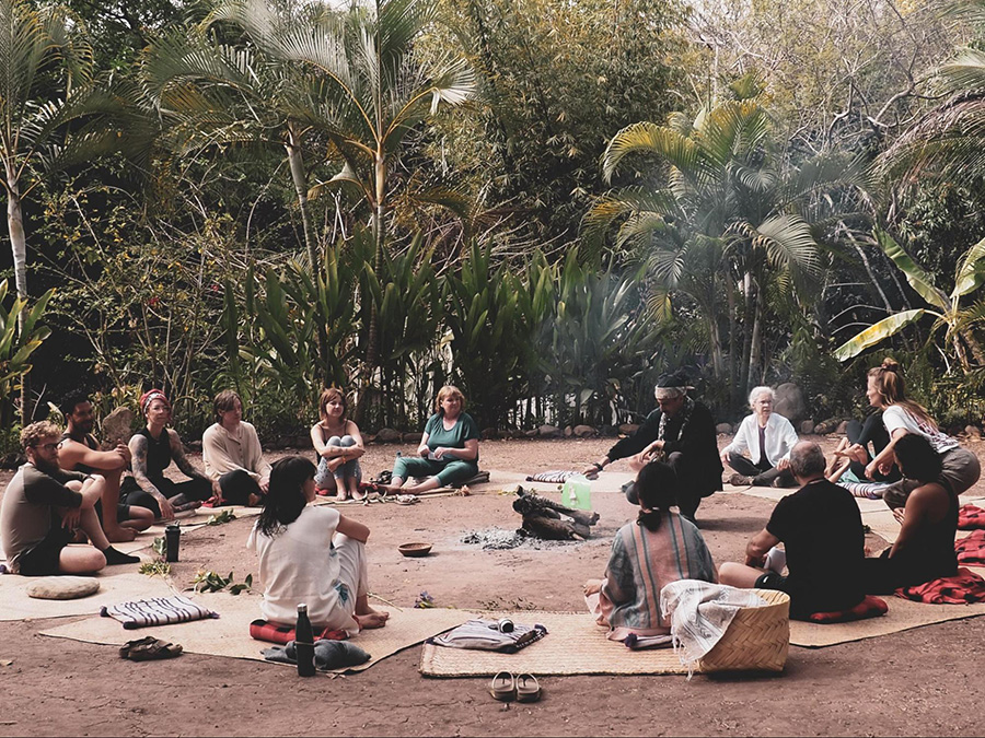 Retreat participants sitting outside in the jungle at Soul Medicine, psilocybin retreat in Nayarit, Mexico.