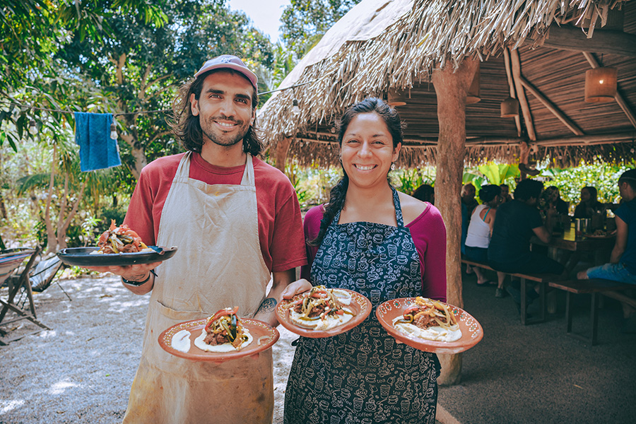 Participants holding plates of food at Soul Medicine in Nayarit, Mexico.
