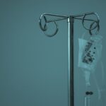 An IV bag on a stainless steel stand, illustrating clinic NAD+ drip pricing against at home programs