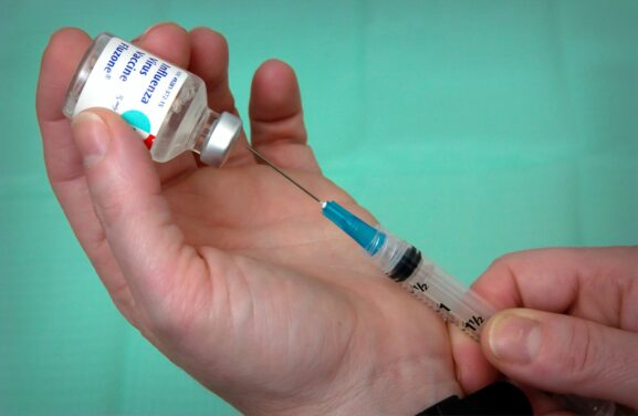 A syringe and medication vial, illustrating sermorelin programs sold online